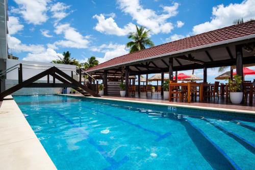 a swimming pool at a resort with a gazebo at Ramada Suites by Wyndham Wailoaloa Beach Fiji in Nadi