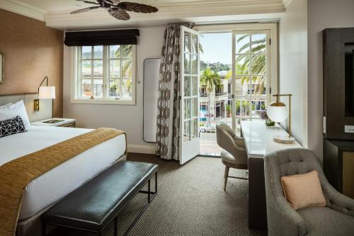 a hotel room with a bed and a desk and a window at La Valencia Hotel in San Diego