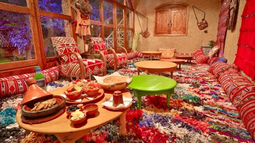a living room filled with lots of tables and chairs at ferme by Ikalimo in Ourika
