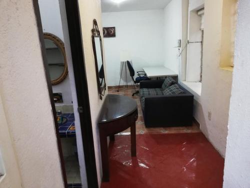 a room with a table and a chair in a room at Hostal Centro de Coyoacan in Mexico City
