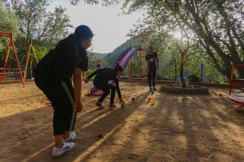 a group of people playing with balls in a playground at ferme by Ikalimo in Ourika