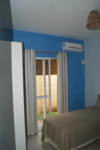 Ένα ή περισσότερα κρεβάτια σε δωμάτιο στο Seu Lar em Milagres