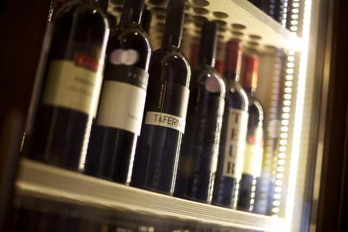 a bunch of bottles of wine sitting on a shelf at Kinder- & Gletscherhotel Hintertuxerhof in Tux