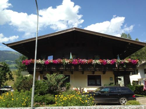 a house with flower boxes on the front of it at Haus Tenk in Mittersill