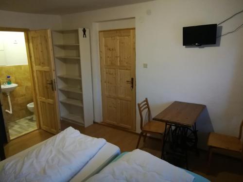 a bedroom with a bed and a table and a desk at U Dragouna in Köllein