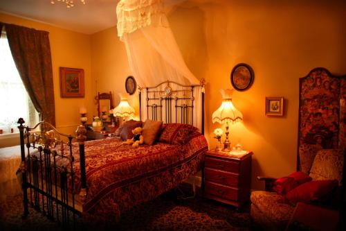 a bedroom with a bed with a teddy bear on it at Blakes Manor Self Contained Heritage Accommodation in Deloraine