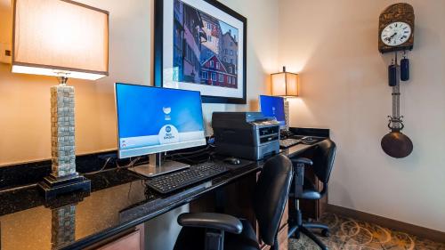 a hotel room with a desk with a computer on it at Best Western Swiss Clock Inn in Pecos