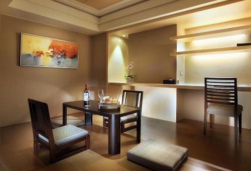 a dining room with a table and two chairs at Sun Moon Lake Hotel in Yuchi