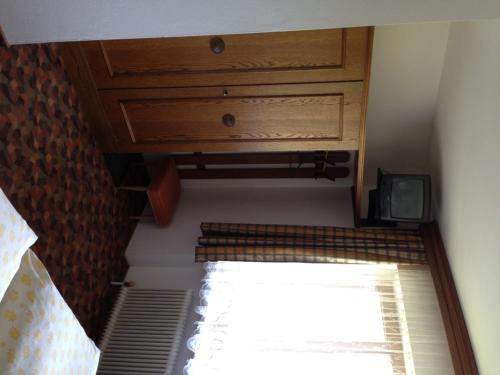 an attic view of a room with a window and a cabinet at Haus Tenk in Mittersill