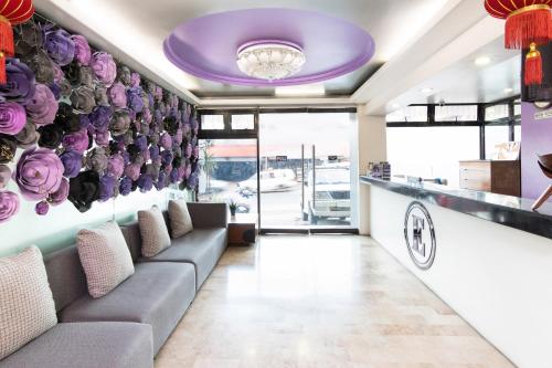 a waiting room with purple flowers on the wall at OYO 175 Hotel Elegant in Baguio