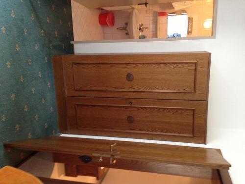 a dresser in a bedroom with a mirror at Haus Tenk in Mittersill