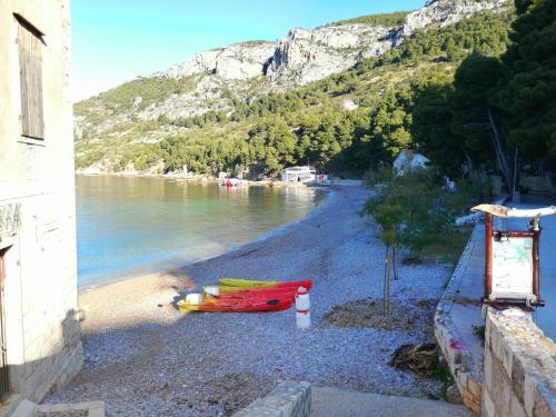 a beach with a group of boats on the shore at Bed and Breakfast BLUE in BLUE in Komiža
