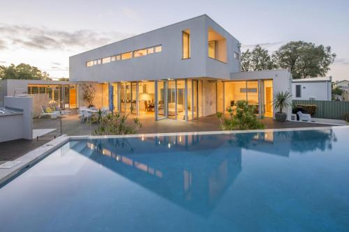a house with a swimming pool in front of it at Cinque in Dunsborough