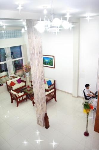 a man sitting in a room with a pillar at Del Castillo Plaza Hotel Pucallpa in Pucallpa