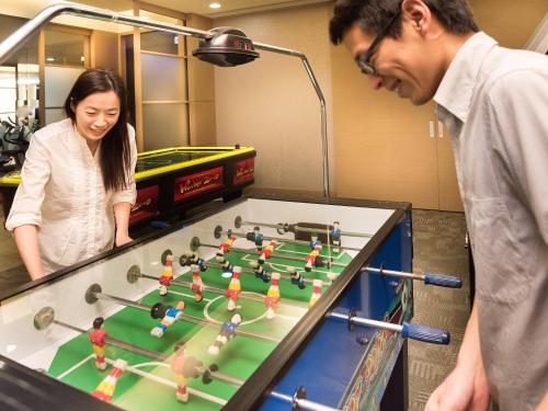a man and a woman looking at a table with at Sun Moon Lake Hotel in Yuchi