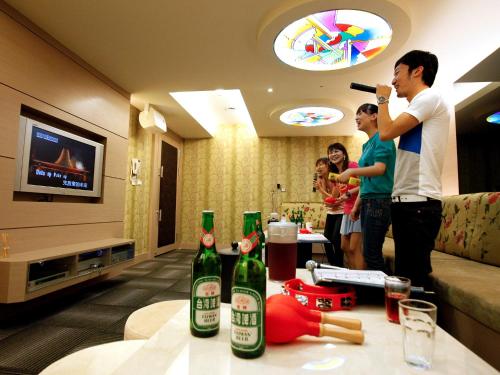 a group of people in a living room playing a video game at Sun Moon Lake Hotel in Yuchi