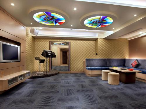 a living room with a couch and a tv at Sun Moon Lake Hotel in Yuchi