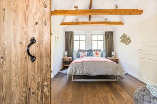 a bedroom with a bed and a wooden wall at Traumhafte Wohnung mit Sauna - 100m vom Strand in Rerik