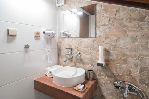 a bathroom with a sink and a mirror at RESTAURACE A PENZION U DOUBKŮ in Břeclav