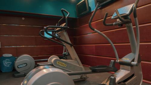 a gym with a treadmill next to a wall at Historic Boutique Hotel Cattaro in Kotor