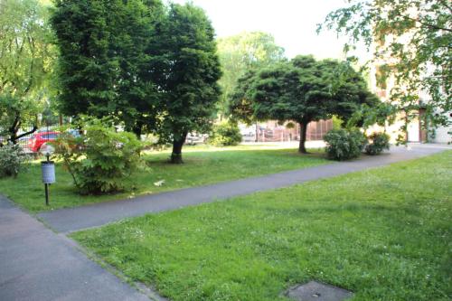 a walking path in a park with trees and grass at Sofia Sweet Home - Corsico in Corsico