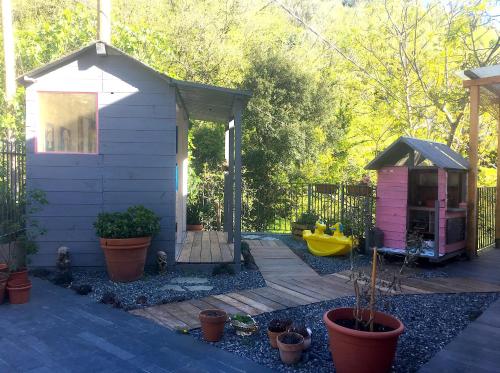 a backyard with a small house and potted plants at Villa Giuanne in Arenzano