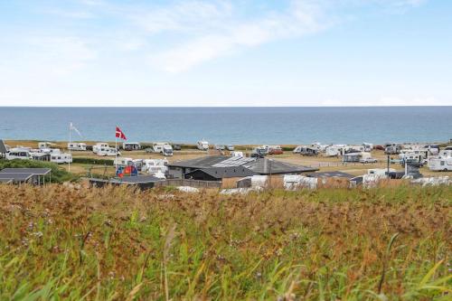 a view of a beach with houses and the ocean at Hirtshals Camping in Hirtshals