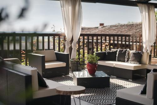 a patio with couches and a table at Chambres d'Hôtes Le Pignié in Lescure-dʼAlbigeois