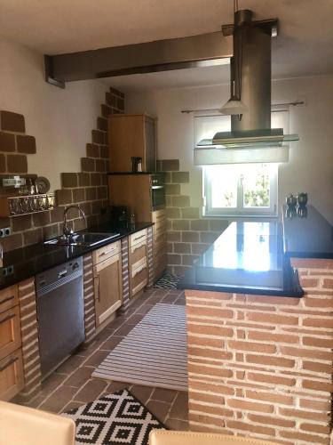 a kitchen with a brick wall at Ferienwohnung Fam.Stuchlik in Winkl