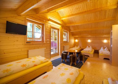 a log cabin bedroom with a desk and a table at Ferienhof Schwehr in Salem