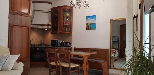 a kitchen with a wooden table and a kitchen with a stove at San Nicolò in Umag