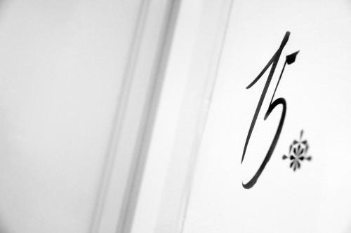 a letter k on a white wall with a snowflake at 1891 Hildesheim Boutique Hotel in Hildesheim