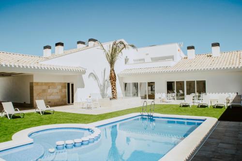 a villa with a swimming pool and a house at Casa Boquera in Carche