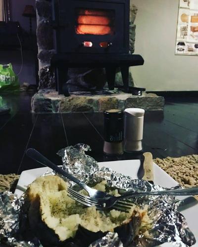 a plate of food in front of a fireplace at Vanilla Grey in Had Nes