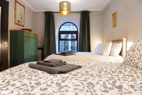 Cama ou camas em um quarto em Talbot Coach House