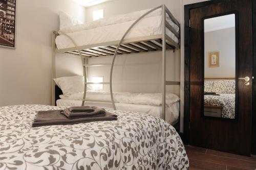 a bedroom with two bunk beds and a mirror at Talbot Coach House in Dublin