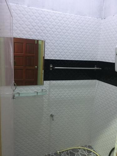 a bathroom with a glass door and a mirror at CM HOMESTAY in Kampung Raja