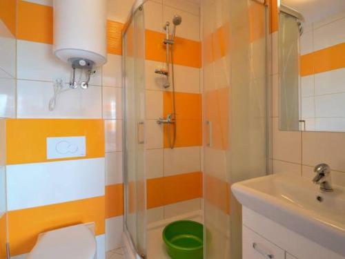a bathroom with a shower and a toilet and a sink at Willa Natenczas in Jarosławiec