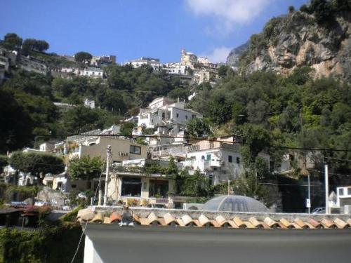 a group of buildings on a hill with houses at La Mammola in Positano