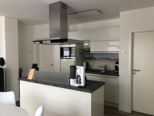 a kitchen with a counter with a coffee maker on it at Prerow „Seaside“-strandnah! in Prerow