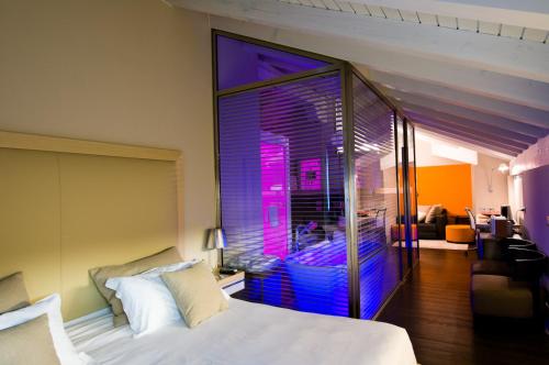 a bedroom with a bed and a large window at Active Hotel in Castione della Presolana