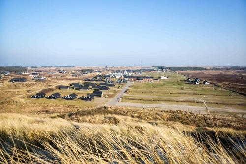 an aerial view of a farm with tents in a field at Hvide Sande Beach Apartments in Hvide Sande