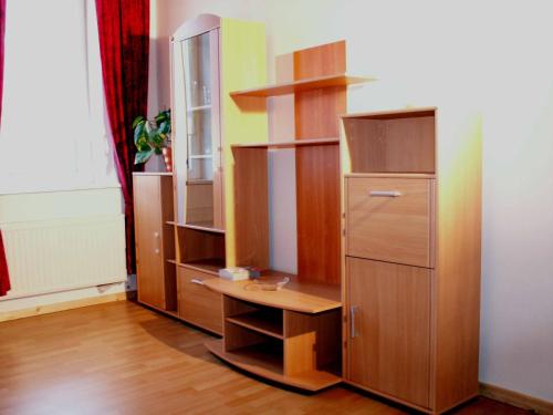 a room with wooden shelves and a desk at Ferienwohnung Köhler in Goslar