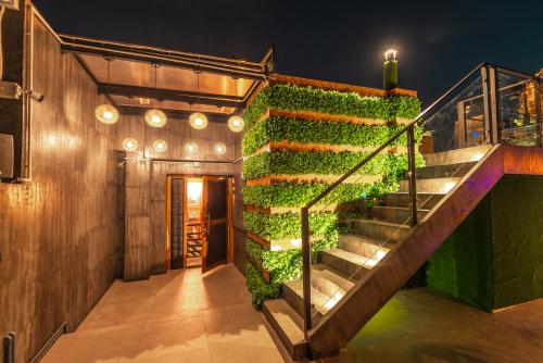 a staircase covered in green ivy in a building at The Hotel Nova in Mandalay