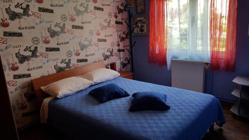 a bedroom with a blue bed with two pillows on it at Filip Apartment in Zadar