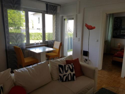 a living room with a white couch and a table at Lotus in Trier