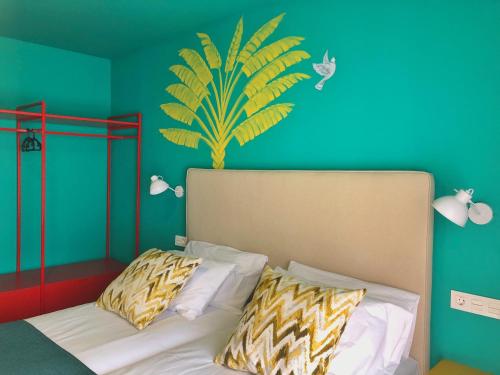 a bedroom with a bed with a plant on the wall at Hotel Ritual Maspalomas - Adults Only in Playa del Ingles