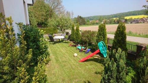 a garden with some toys on the grass at Ferienwohnung Landluft in Ostercappeln
