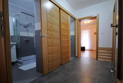 a bathroom with a shower and a glass door at Guest House Korita in Grabovac