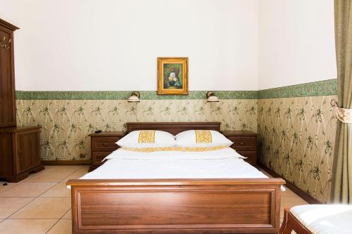 a bedroom with a wooden bed in a room at Residenz Selena in Ustka